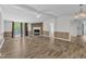 Open living room with wood floors, fireplace, ceiling fan and sliding glass doors to a balcony at 64 Doughty Ln # E, Middlesex, NC 27557
