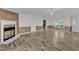 Spacious living room with a fireplace, wood floors, and a ceiling fan at 64 Doughty Ln # E, Middlesex, NC 27557