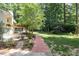 Beautiful backyard with a brick path and manicured garden, a tranquil outdoor retreat at 6609 Electra Dr, Raleigh, NC 27607