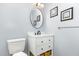 Bathroom featuring a white vanity, a round mirror and gray walls at 6609 Electra Dr, Raleigh, NC 27607