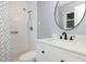 Bathroom featuring white tiles, a glass shower and a white vanity with a black faucet at 6609 Electra Dr, Raleigh, NC 27607