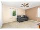 Bedroom with a gray sofa, ceiling fan and a window with sheer curtains at 6609 Electra Dr, Raleigh, NC 27607