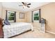 Cozy bedroom featuring a bed, two windows, and neutral-colored walls at 6609 Electra Dr, Raleigh, NC 27607