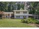 Charming two-story home with a well-manicured lawn and mature trees, showcasing classic curb appeal at 6609 Electra Dr, Raleigh, NC 27607