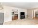 Cozy living room features neutral carpet, TV, and entrance to dining area at 6609 Electra Dr, Raleigh, NC 27607