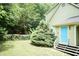 Charming backyard features a lush lawn, stepping stones, and a light-blue door at 7216 Rabbit Run, Wake Forest, NC 27587