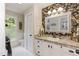 Stylish bathroom with decorative wallpaper, large mirror, and plenty of natural light at 7216 Rabbit Run, Wake Forest, NC 27587