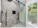 Modern tiled shower with glass door and window at 7216 Rabbit Run, Wake Forest, NC 27587