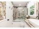 Stylish bathroom with brick accent wall, glass shower door, and garden window at 7216 Rabbit Run, Wake Forest, NC 27587