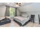 Comfortable bedroom with a ceiling fan, a large window, and modern decor in a relaxing setting at 7216 Rabbit Run, Wake Forest, NC 27587