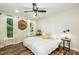 Relaxing bedroom with decorative clock, ceiling fan, and natural light from large windows at 7216 Rabbit Run, Wake Forest, NC 27587