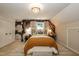 Charming bedroom showcases floral accent wall, chandelier, and neutral carpet at 7216 Rabbit Run, Wake Forest, NC 27587