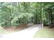 Long driveway leading to a home surrounded by trees at 7216 Rabbit Run, Wake Forest, NC 27587
