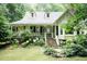 Inviting home showcasing a quaint porch and well-kept landscaping at 7216 Rabbit Run, Wake Forest, NC 27587