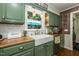 Bright kitchen features wood counters, a stainless steel dishwasher, and a farmhouse sink at 7216 Rabbit Run, Wake Forest, NC 27587
