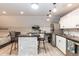 Bright kitchenette with a center island, stainless steel appliances, and modern fixtures at 7216 Rabbit Run, Wake Forest, NC 27587