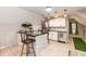 Stylish kitchenette with white cabinetry, dark countertops, stainless steel appliances, and an eat-in island at 7216 Rabbit Run, Wake Forest, NC 27587