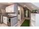 Modern kitchenette featuring white cabinets, subway tile backsplash, and stainless steel appliances in a cozy setting at 7216 Rabbit Run, Wake Forest, NC 27587