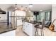 Open living area featuring stainless steel appliances, an eat-in island, and modern furniture with natural light at 7216 Rabbit Run, Wake Forest, NC 27587