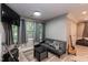 Bright living area featuring a comfortable couch, modern furnishings, and ample natural light at 7216 Rabbit Run, Wake Forest, NC 27587