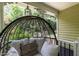 Close-up of comfortable wicker chair on the porch, perfect for relaxation and enjoying the outdoors at 7216 Rabbit Run, Wake Forest, NC 27587