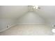 This large attic bonus room offers additional ceiling lighting and ample carpeted space at 747 Weathergreen Dr, Raleigh, NC 27615