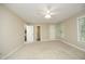 Spacious bedroom features a ceiling fan, neutral carpet, and natural light at 747 Weathergreen Dr, Raleigh, NC 27615
