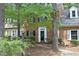Charming brick townhome with manicured landscaping and inviting front entrance with black door and white trim at 747 Weathergreen Dr, Raleigh, NC 27615