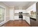 Bright kitchen featuring white cabinets, stainless steel appliances, and granite countertops at 747 Weathergreen Dr, Raleigh, NC 27615