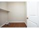 Convenient laundry room with wood floors and built-in shelf at 747 Weathergreen Dr, Raleigh, NC 27615
