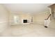 Spacious living room featuring a cozy fireplace, neutral carpet, and natural light at 747 Weathergreen Dr, Raleigh, NC 27615