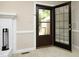 Living room with glass paneled back door and brick fireplace at 747 Weathergreen Dr, Raleigh, NC 27615