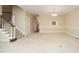 Inviting living room with staircase, neutral carpet, and chandelier lighting at 747 Weathergreen Dr, Raleigh, NC 27615