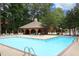 Large community swimming pool surrounded by lounge chairs and a covered picnic area at 747 Weathergreen Dr, Raleigh, NC 27615