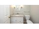 Renovated half bath boasts granite counters and modern fixtures at 747 Weathergreen Dr, Raleigh, NC 27615