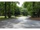 Picturesque neighborhood street lined with mature trees, creating a serene and inviting atmosphere at 747 Weathergreen Dr, Raleigh, NC 27615