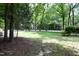 Expansive front yard with mature trees and lush green grass at 747 Weathergreen Dr, Raleigh, NC 27615