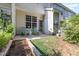 Cozy back patio with green chairs, garden plot, and access to the house, perfect for relaxing at 7648 Winners Edge St, Raleigh, NC 27617