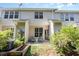 Inviting back patio featuring comfortable seating and a well-maintained yard with raised garden at 7648 Winners Edge St, Raleigh, NC 27617