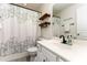 Bathroom featuring a white vanity, tub and floating shelves at 7648 Winners Edge St, Raleigh, NC 27617