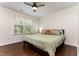 Bedroom featuring hardwood floors, ceiling fan and a window that lets in plenty of light at 7648 Winners Edge St, Raleigh, NC 27617