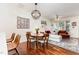 Dining area featuring hardwood floors, a modern chandelier, and seating for four at 7648 Winners Edge St, Raleigh, NC 27617
