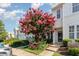 Townhome exterior with blooming crape myrtle, inviting curb appeal on a sunny day at 7648 Winners Edge St, Raleigh, NC 27617