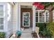 Cozy front porch with brick accents, decorated with potted plants and cheerful decor at 7648 Winners Edge St, Raleigh, NC 27617