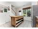 Bright kitchen with an island, stainless refrigerator, a window with shade and stairs at 7648 Winners Edge St, Raleigh, NC 27617
