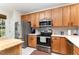 Bright kitchen with stainless steel appliances and light wood cabinetry with modern tile backsplash at 7648 Winners Edge St, Raleigh, NC 27617