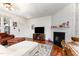 Inviting living room with fireplace, hardwood floors, and open layout to the dining area at 7648 Winners Edge St, Raleigh, NC 27617