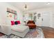 Bright living room with large windows, stylish decor, and comfortable seating arrangement at 7648 Winners Edge St, Raleigh, NC 27617