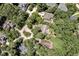 An aerial view shows mature trees surrounding homes in a wooded neighborhood at 81106 Alexander, Chapel Hill, NC 27517