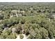 Aerial view of a wooded property featuring mature trees and located near a golf course and a lake at 81106 Alexander, Chapel Hill, NC 27517